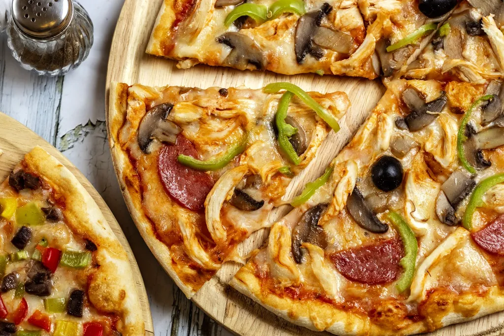 top-view-chicken-pizza-with-salami-mushrooms-bell-pepper-chicken-black-olive.webp